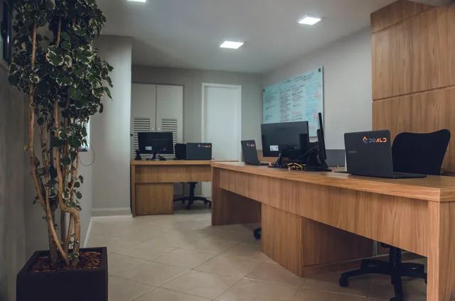 Contemporary office space featuring desks with computers and revolving chairs. Web design agencies outlook: UK evidence limits